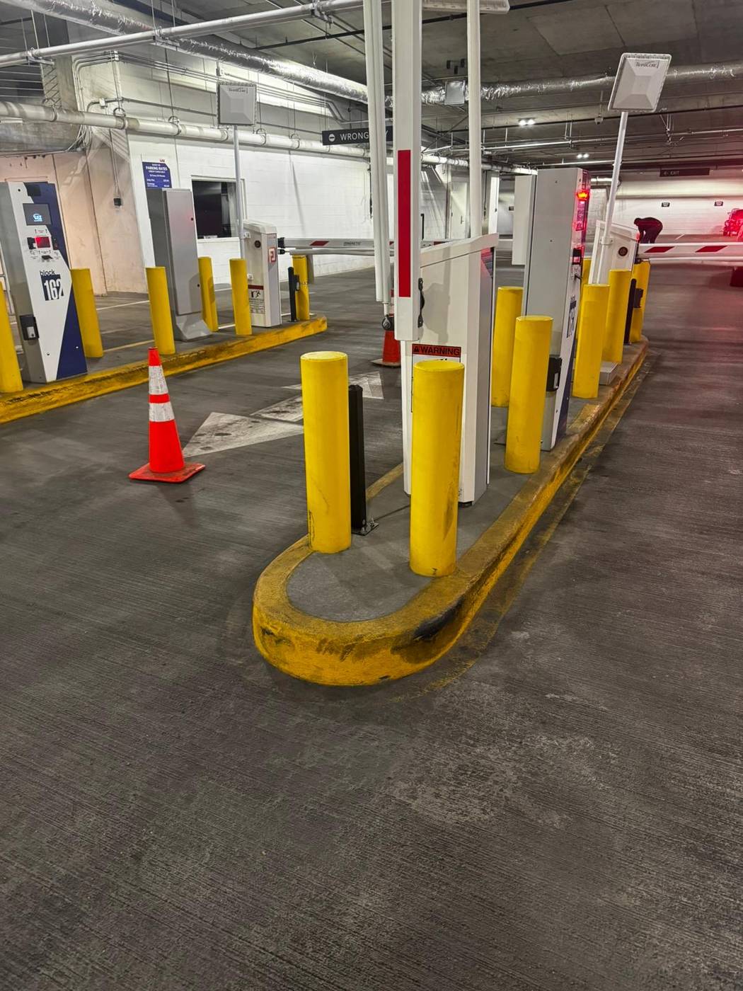 Striped garage curb and protective bollards